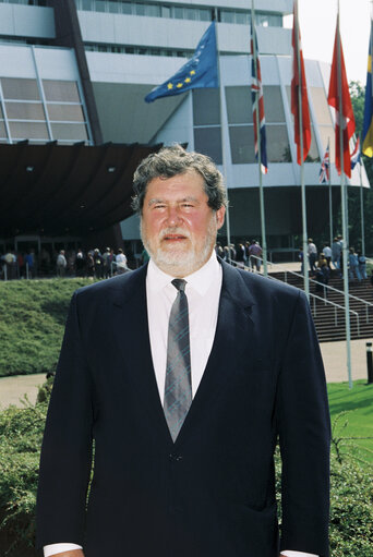 Fotografija 1: Poprtrait of Claude A F DELCROIX in front of the flags at the EP in Strasbourg