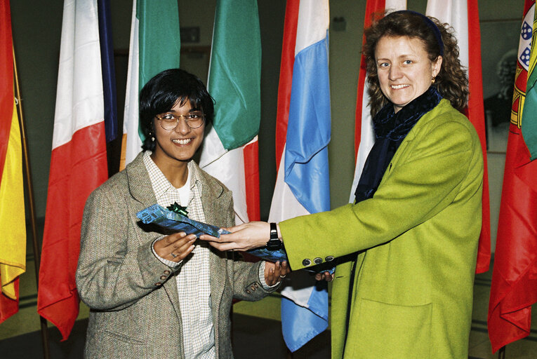 MEP with a guest in front of flags