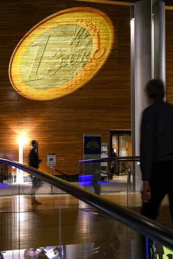 Fotografie 1: ' Euro at 20 '  for the 20th anniversary of the Euro - Projection of Euro coin logo on Hemicycle wooden wall