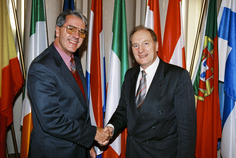Photo 1: Gordon ADAM with guests in front of flags