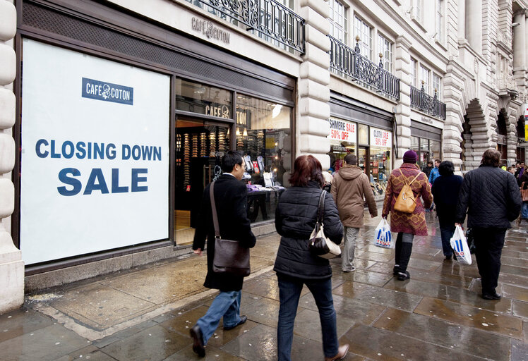 Shops in UK with posters in showcases during the financial crisis