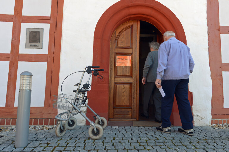Elder people walk into a polling station in Hinternah near Hildburghausen.