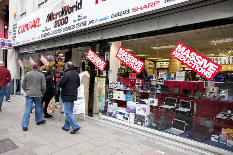 Shops in UK with posters in showcases during the financial crisis