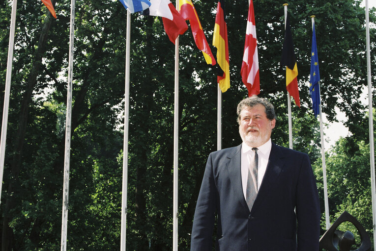 Fotografija 2: Poprtrait of Claude A F DELCROIX in front of the flags at the EP in Strasbourg