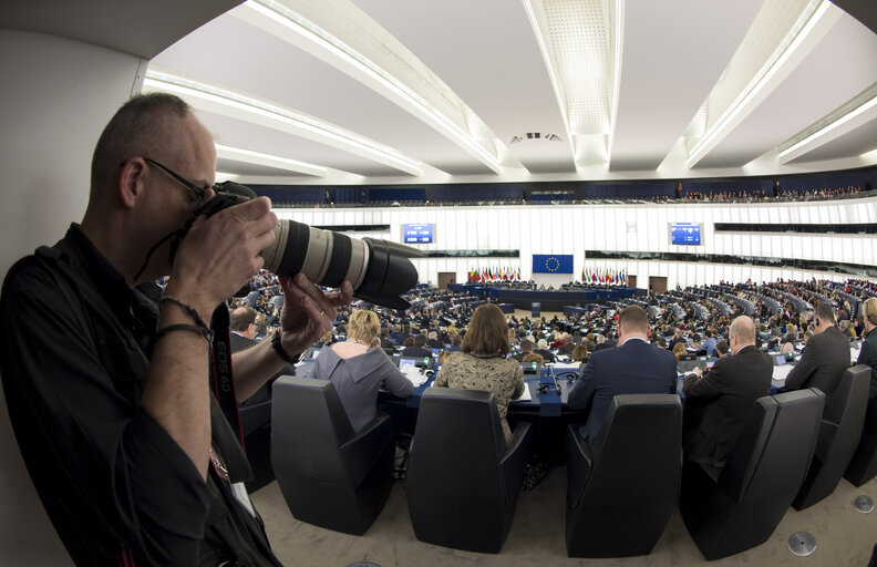 Plenary session week 10 2016 in Strasbourg.  Wide angle view of the plenary chamber. Hemicycle.  Photographer in action. Fisheye.