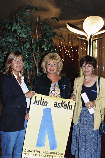 Barbara DUHRKOP, Nicole PERY, Ana MIRANDA DE LAGE with blue ribbons, symbol of protest against the Basque separatist organisation Eta and a poster.