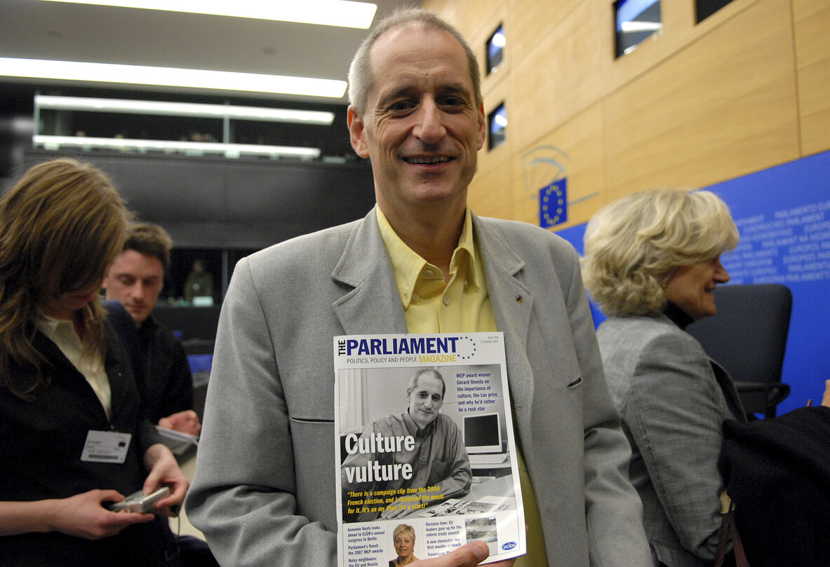 MEP Gerard ONESTA poses with an issue of The Parliament magazine after a press conference in Strasbourg