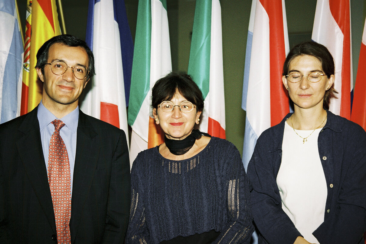 Maria IZQUIERDO ROJO with guests in front of flags