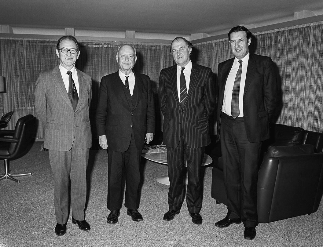 Lord HENRI PLUMB meets with guests in his office