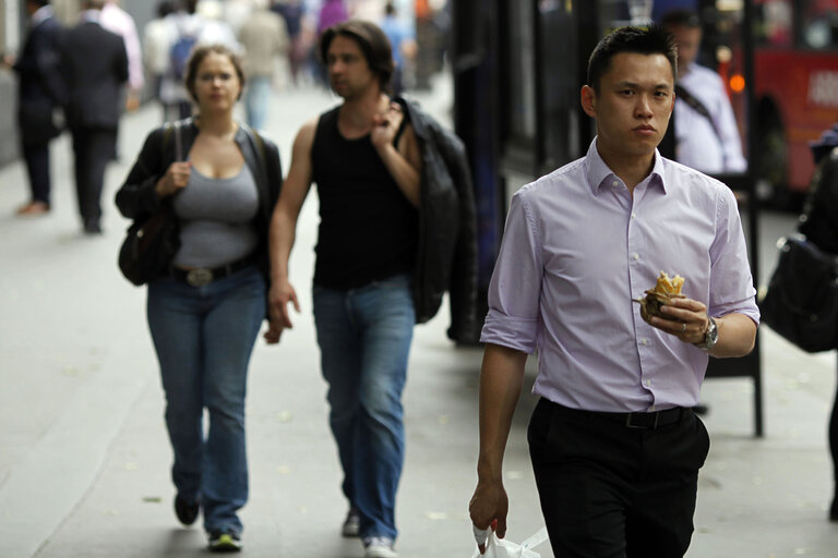 Commuters eat outside in the streets.