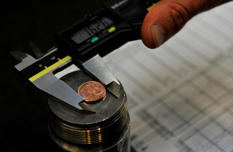 A worker of  Zecca dello Stato checks the Italian euro coins during printing  in Rome