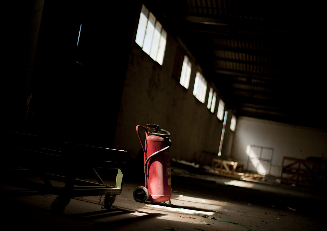 A fire extinguisher in an abandoned factory