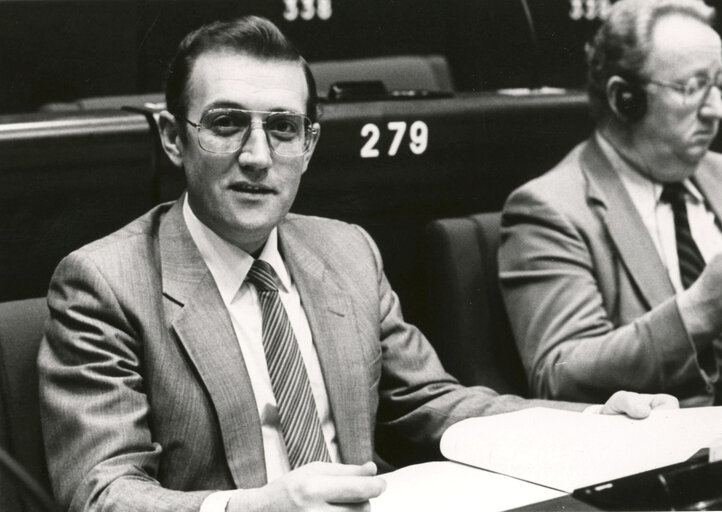 Brian M. KEY attends a plenary session in December 1982