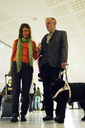 A blind man walks with his dog inside the EP in Brussels