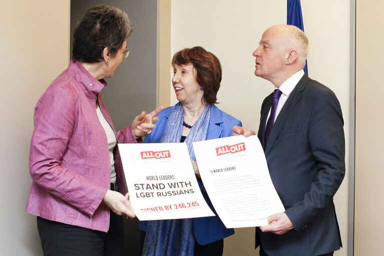 Ulrike LUNACEK, Catherine ASHTON and Michael CASHMAN pose with a poster Stand with LGBT Russians
