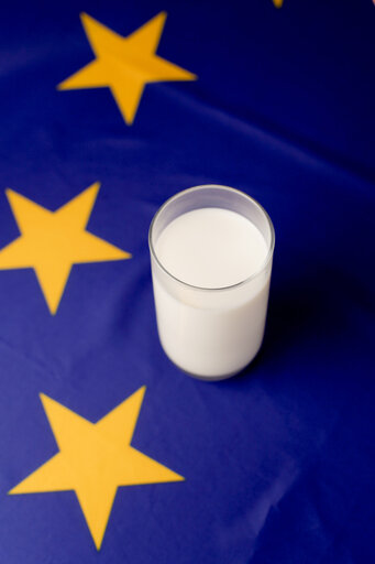 Glass of milk upon a European flag