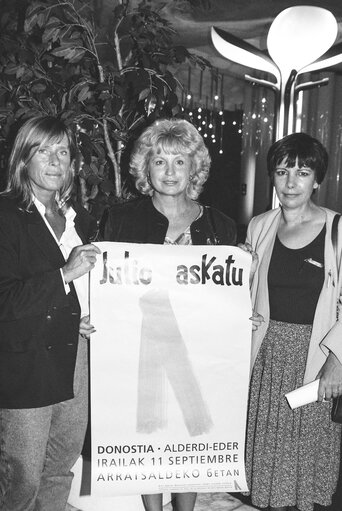 Barbara DUHRKOP, Nicole PERY, Ana MIRANDA DE LAGE with blue ribbons, symbol of protest against the Basque separatist organisation Eta and a poster.