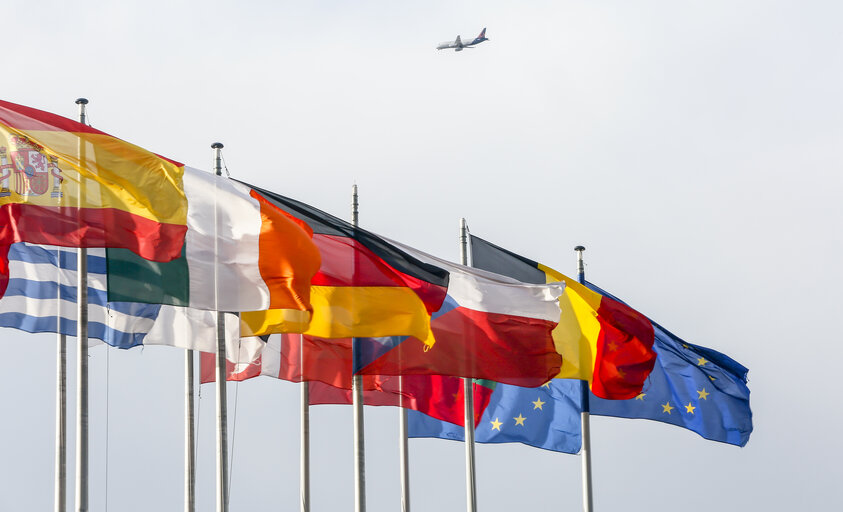 Photo 3: European flags in front of EP building and plane in the sky in Strasbourg