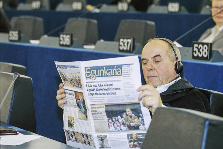 MEP Miquel MAYOL I RAYNAL reading a newspaper in Plenary Session in Strasbourg