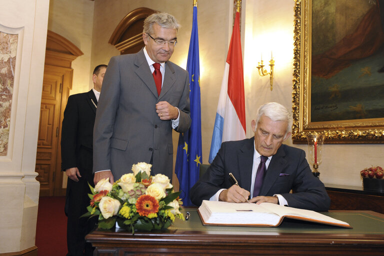 European Parliament President Jerzy Buzek signs the golden book of the Chamber of Deputies of Luxembourg while the President of the Chamber Laurent Mosar (L) looks on, on November 09, 2010 in Luxembourg.