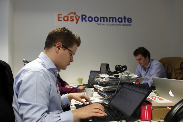 Men and women at work. Staff members are seen at the Easyroommate.com website office  in London