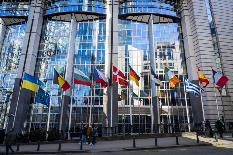 EU and Greek flags at half mast at the EP building in Brussels, in solidarity with the victims of a train crash in Greece